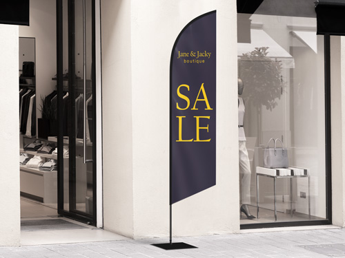 Advertising and promotional feather flag reading Sale in yellow on a dark background.
