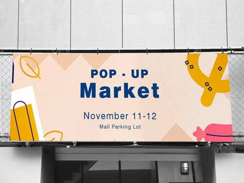 A playful mesh banner reading Pop-Up Market November 11–12 Mall Parking Lot.