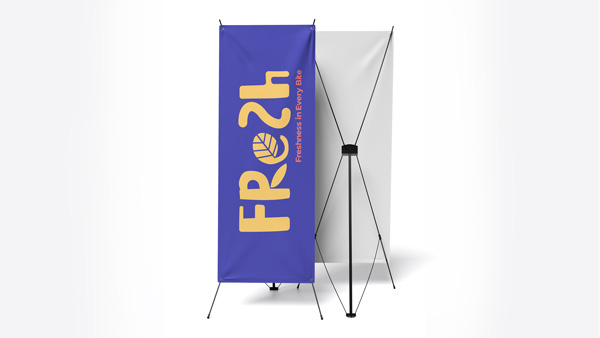Blue X-stand banner with bold yellow FRESH text and minimal design on display.