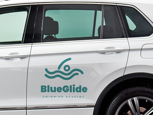 Car window lettering featuring a swimming academy logo and promotional advertising.
