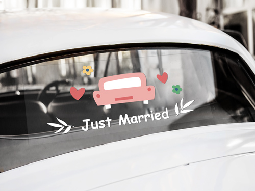 Car window decal celebrating a Just Married couple with festive design.