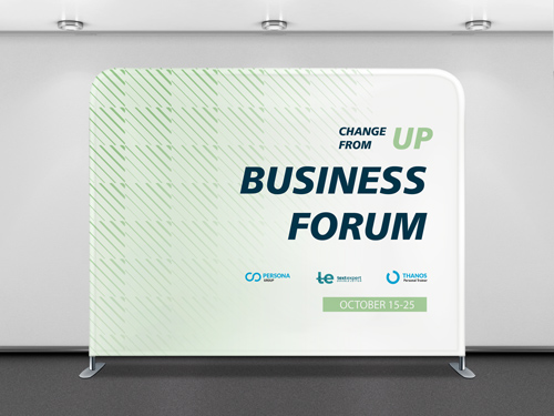 A green and white tension fabric backdrop in a conference environment.