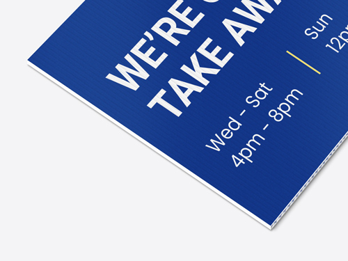Close-up of a corrugated plastic sign with a blue background, displaying working days.