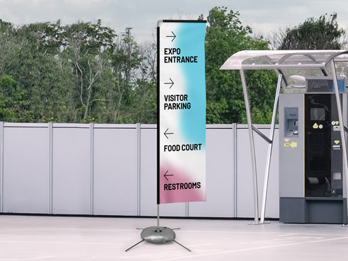Colorful rectangle flag with directional arrows pointing to expo entrance, visitor parking, food court, and restrooms.