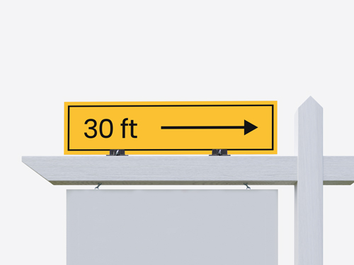A real estate directional rider sign with an arrow, mounted on a metal frame