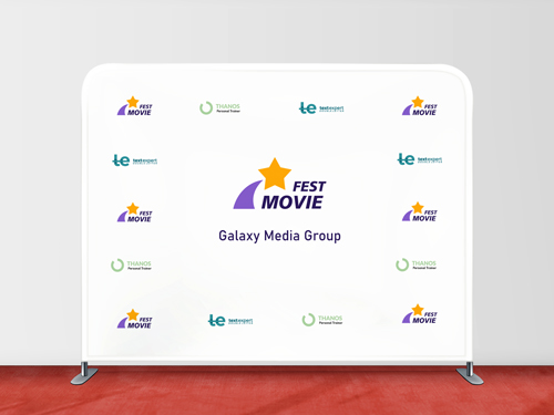 A tension fabric backdrop showcasing a white display placed on a red carpet for a movie festival.