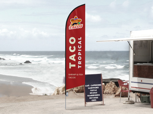 Red feather flag for Taco Tropical restaurant displaying the provided services.