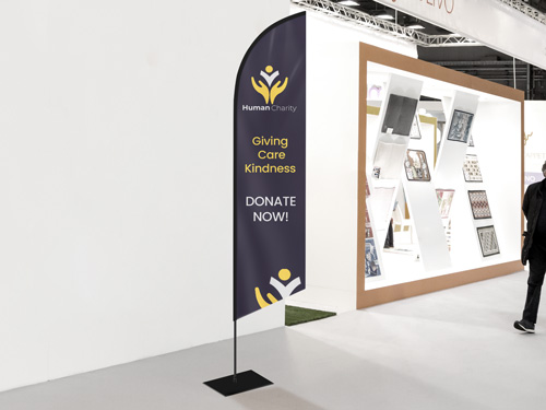 Dark-colored feather flag reading Donate Now with a motivational quote.
