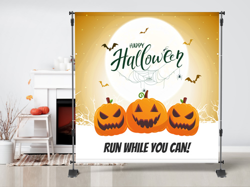 Halloween-themed step and repeat banner reading Run While You Can.