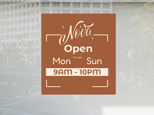 Brown window decal displaying company logo and working hours in a storefront.