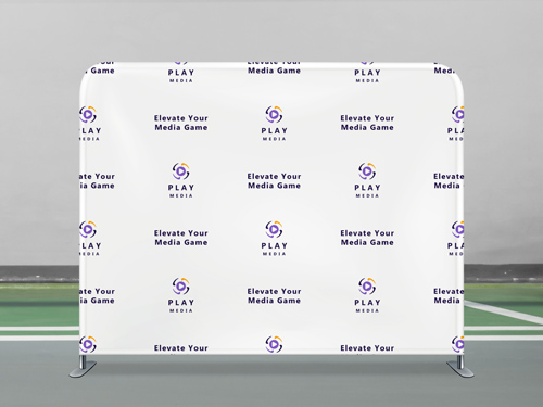 A media tension fabric photo backdrop lined with logos and slogans placed on the sidelines of a soccer pitch.