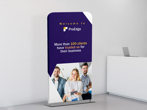 Office branding stand with employee images and an inspirational message.