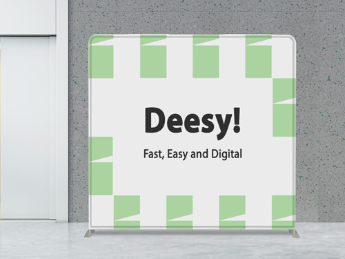 A tension fabric backdrop placed in an office highlighting the brand name and slogan.