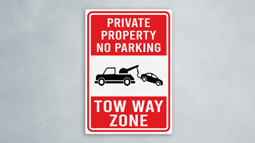 Private Property No Parking Tow-Away Zone sign with truck towing car image.