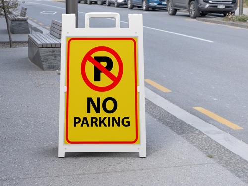 No parking sandwich board with a red P prohibition symbol on a yellow background.