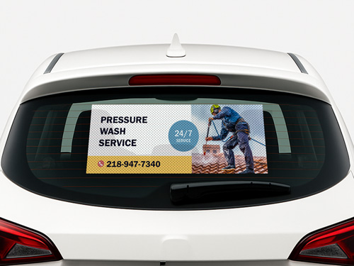 Perforated car window decal advertising pressure wash service with contact details.