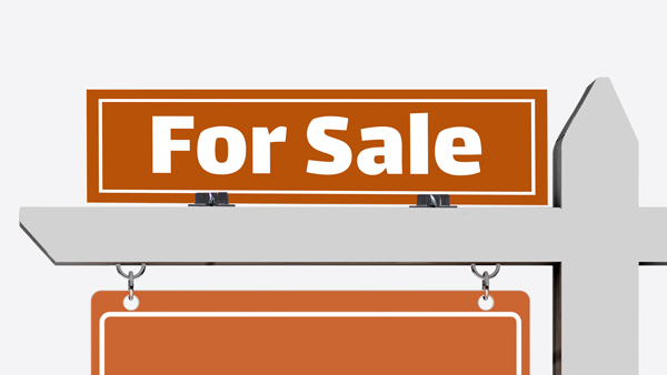 A single custom real estate rider sign mounted on a lawn signpost