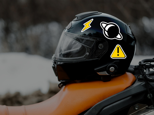Black motorcycle helmet with yellow lightning bolt, planet, and warning reflective decals.