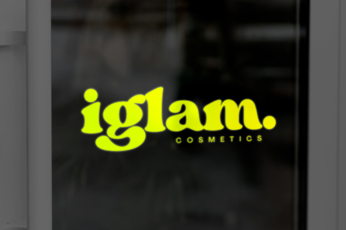 Reflective vinyl letters reading the company name on a dark storefront background.