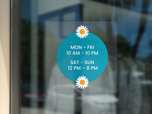 Light blue window cling with business hours, framed by daisies above and below.