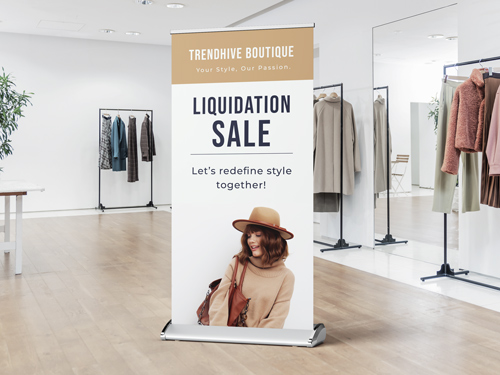 A retractable banner showcasing a liquidation sale happening at a clothing store.