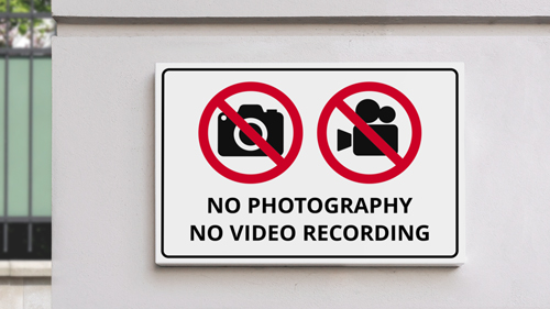 Road safety plastic sign displaying No Photography, No Video Recording.