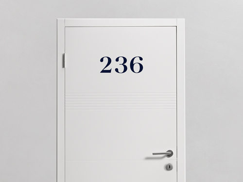 Vinyl room number lettering reading ‘236’ applied to a white door.