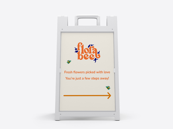 A navigational sandwich board for Flora Bee with flowers, text, and arrow pointing to the right.