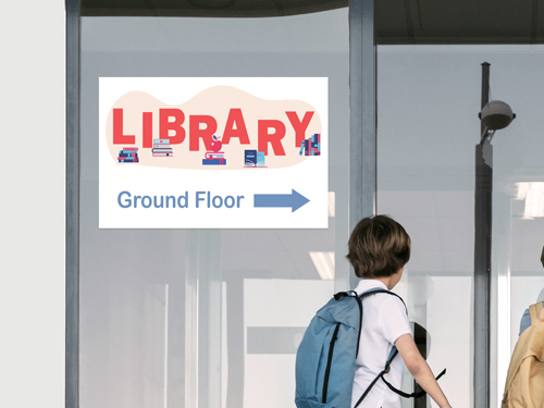 Vibrant window decal displaying Library sign with directional arrow to Ground Floor