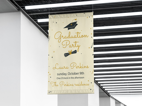 Graduation vinyl banner with hats, date, and Graduation Party text hanging at a school.
