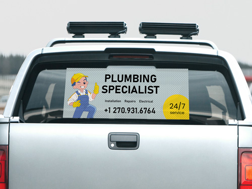 Plumbing Specialist decal with services list, contact info, and plumber image.
