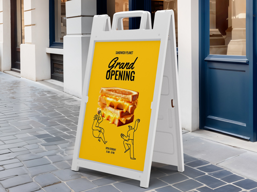 Yellow sandwich board with “Grand Opening,” two men’s silhouettes, and a sandwich image.