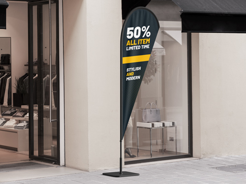 Black teardrop banner flag with 50% All Items Limited Time text outside storefront.