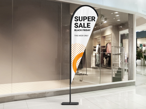 White and orange teardrop banner flag with "Super Sale Black Friday text in mall corridor.