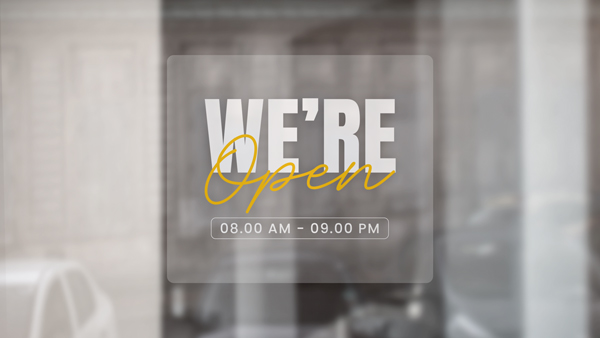 We're Open window cling displaying the working hours.