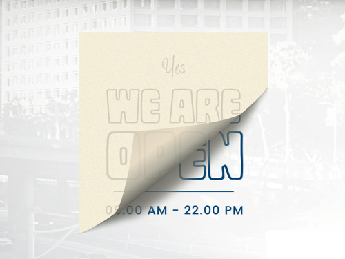 Vinyl window lettering applied to a storefront, showcasing custom-cut text for business names and working hours.